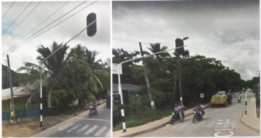 Semáforo vehicular LED en rojo sobre poste mástil con franja amarilla y negra en intersección urbana de Cereté.